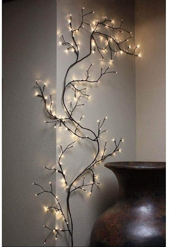 The Light Garden lighted willow vine wall wrap adds warm ambience to a living space.