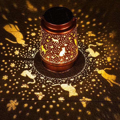 TIGGSY cat solar lantern pattern casts warm light for garden ambiance.