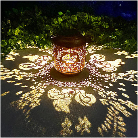 TIGGSY Squirrel Solar Lantern in a garden casting charming shadows at night