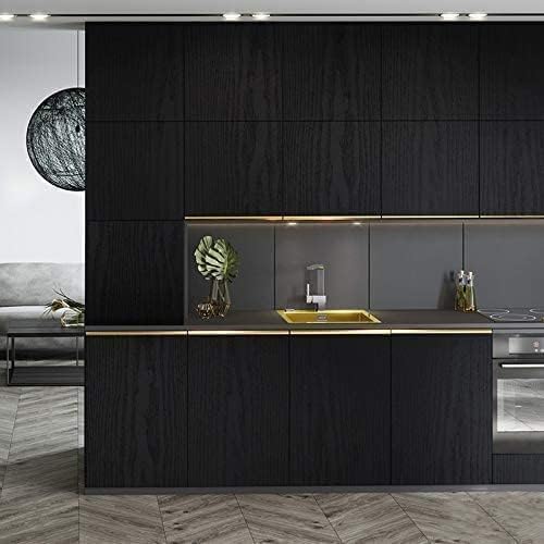 Tiltil Black Wood wallpaper used as kitchen backsplash for easy cleaning.