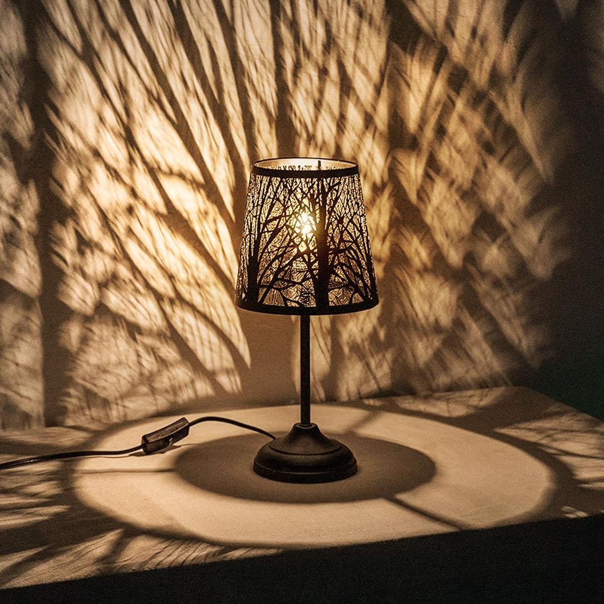 Timeflies black metal tree shadow lamp casts forest silhouettes for warm ambience.