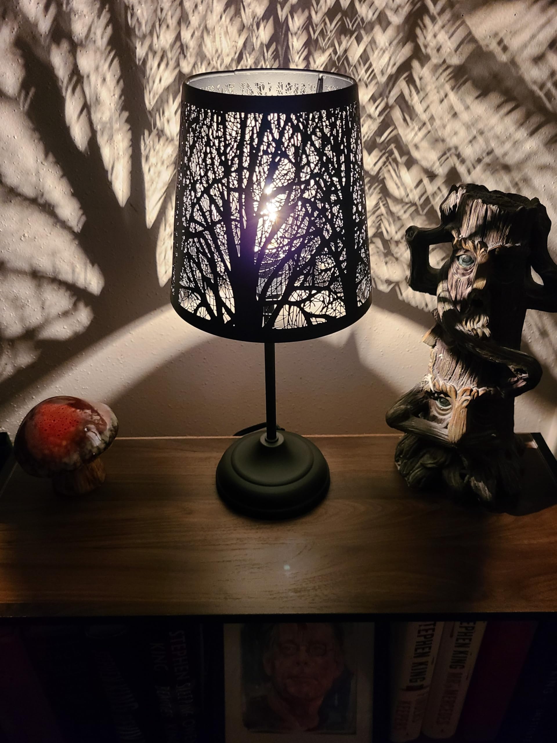 Timeflies forest-pattern shade casts decorative wall art for ambience.