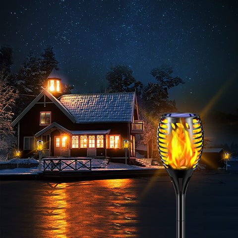 TomCare pathway-illumination torches emit warm yellow glow along walkways.