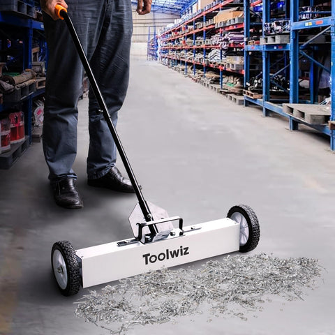 Toolwiz sweeper wheels rolling smoothly over grass for fast yard metal cleanup.
