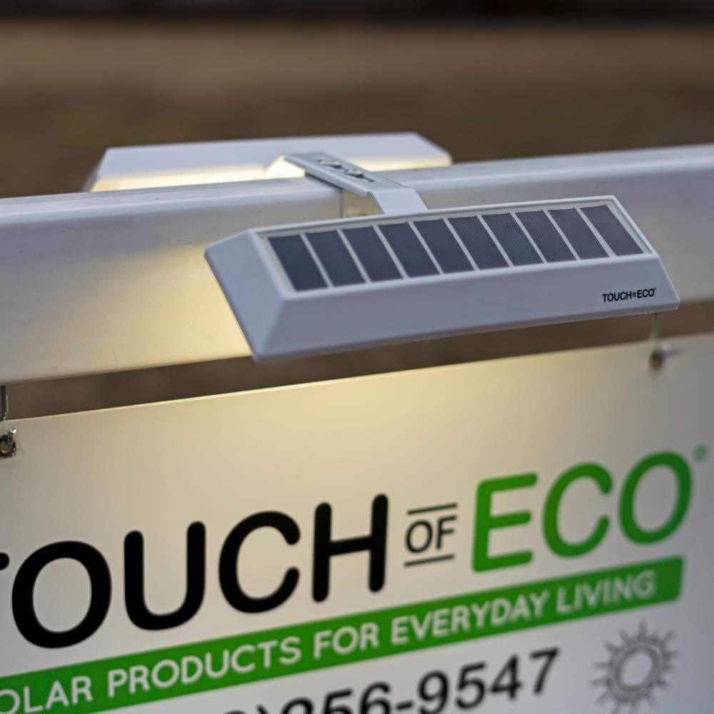 Touch Of ECO LiteAgent Pro real estate sign lighting on outdoor storefront.