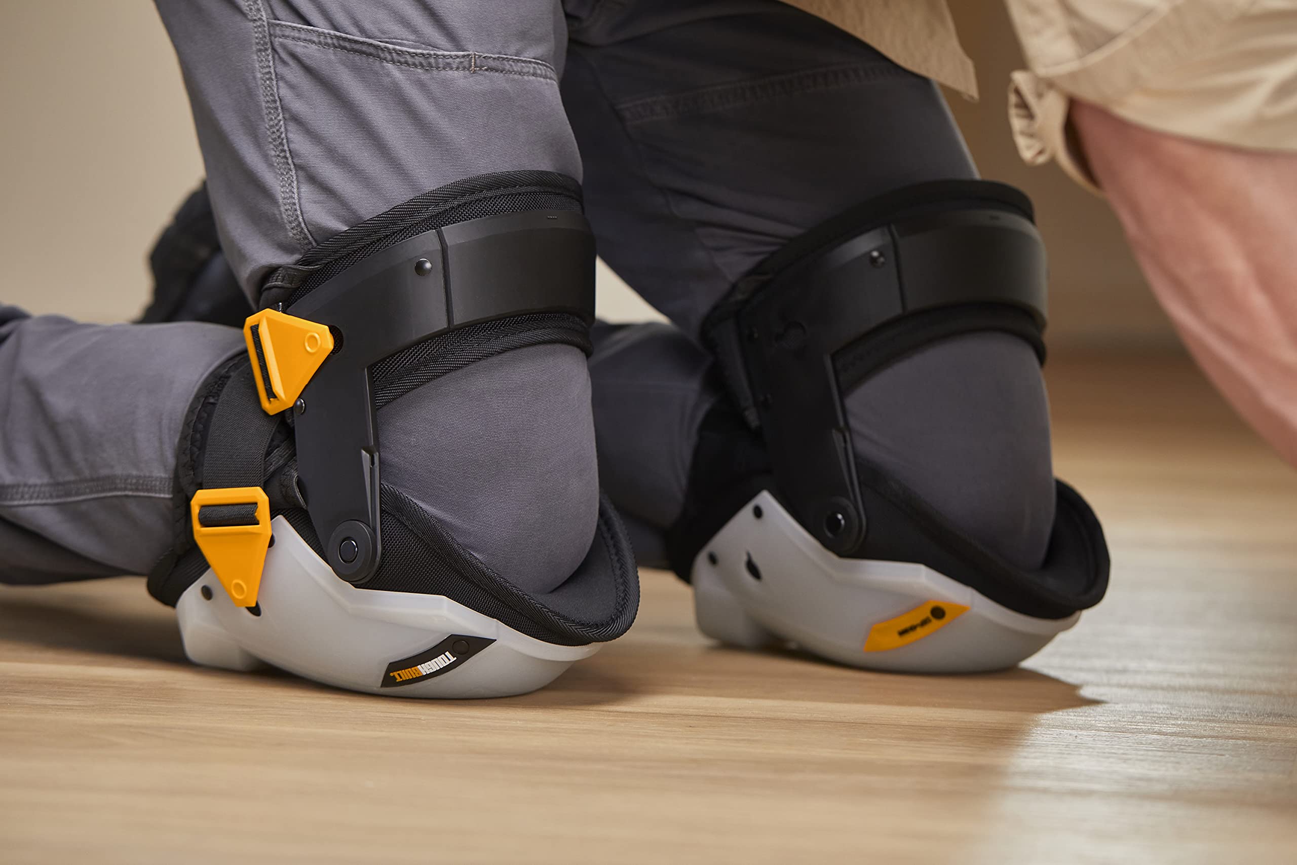 ToughBuilt non-slip grip knee pads strapped securely during flooring work