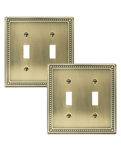 Treewell Pearls double-toggle wall plate in antique brass enhances traditional room cohesion