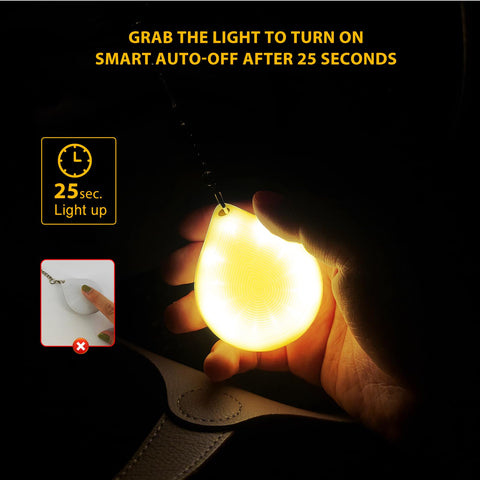 Tubasion purse light with hook shows versatile attachment to a tote