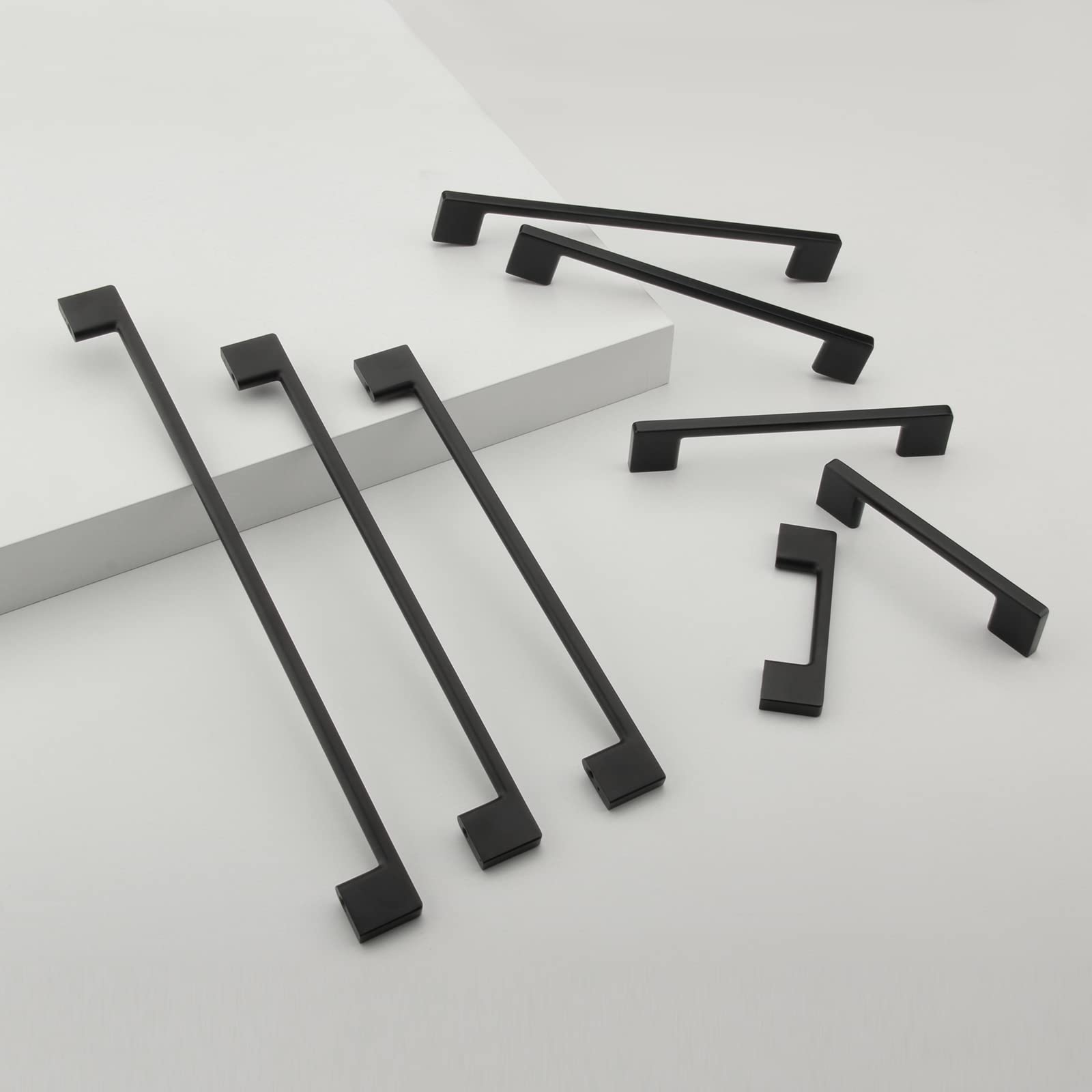 TUNNY matte black kitchen cabinet pulls installed on modern cabinetry.