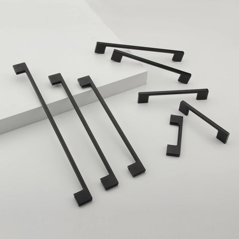 TUNNY matte black kitchen cabinet pulls installed on modern cabinetry.