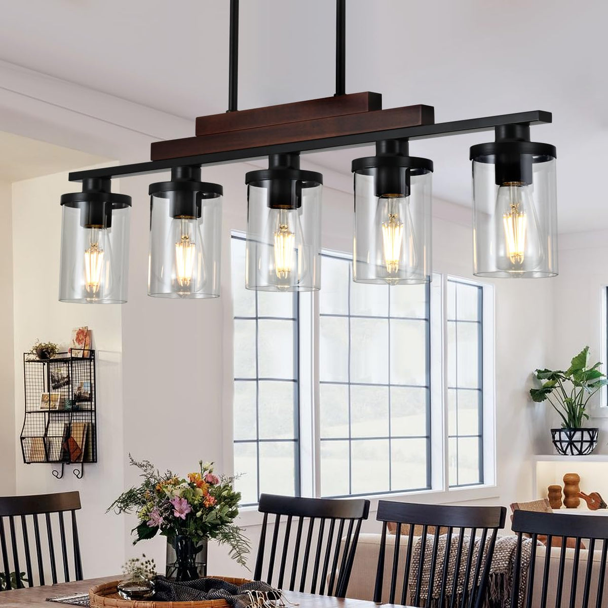 TWIG dining room light fixture with five glass shades for warm table illumination.