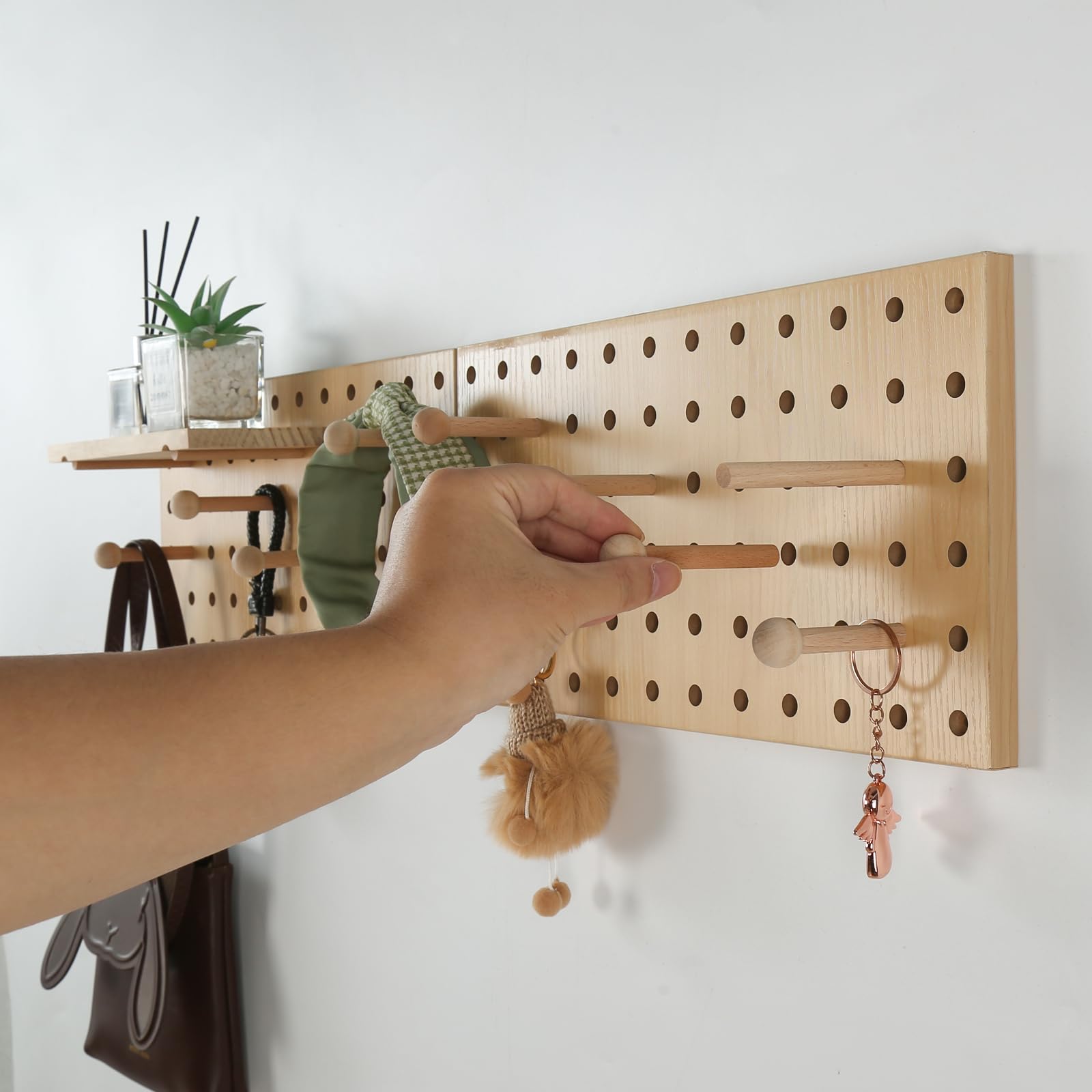 UMICAL beige wood pegboard bathroom organizer holds brushes and toiletries with style.