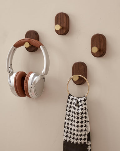 Close-up of brass accent on a wood coat hook for sturdy performance.