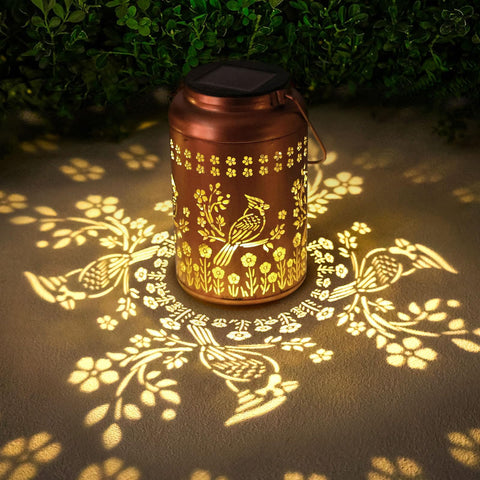WACLSTDAY Cardinal Solar Lantern projects elegant pattern silhouettes in the garden.