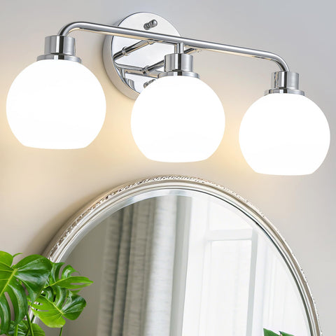 Watyo chrome vanity light over mirror with milk glass shades for balanced illumination.