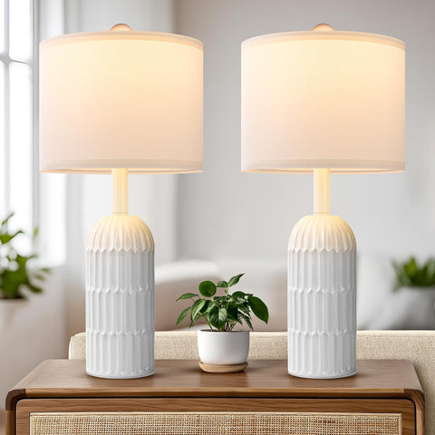 Weddeg two-pack white table lamps on a nightstand provide balanced bedside lighting.