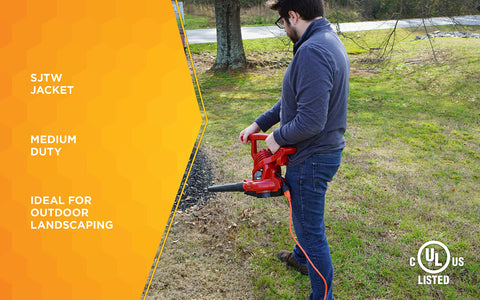 Woods 50ft orange extension cord on a worksite improves visibility and safety