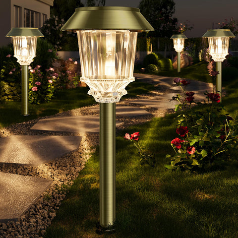 XMCOSY+ bronze outdoor solar pathway lights illuminating a stone path at dusk