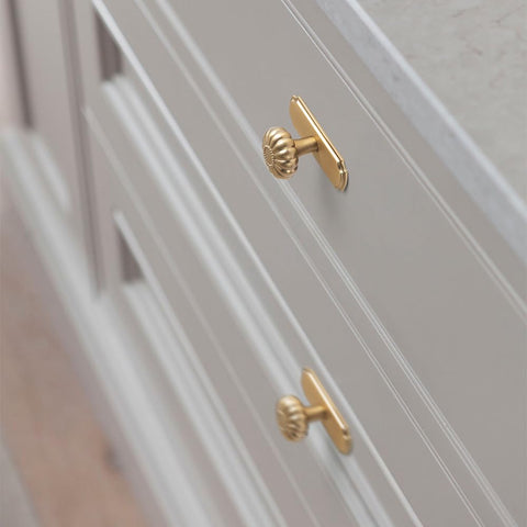 Yanxia champagne bronze finish on a knob for warm cabinet appeal.