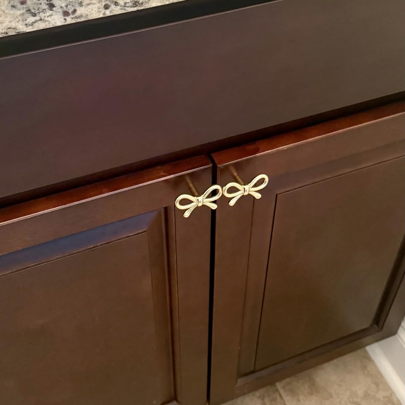YEMCHI brass bow knob on a bookcase elevates interior design.