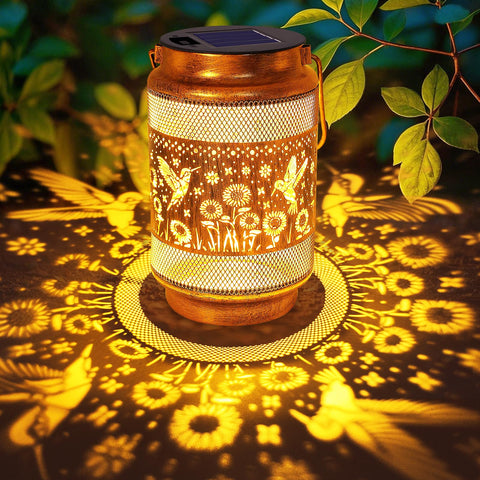 Yulloyello hummingbird lantern in gold bronze casts warm garden glow for patios at night.