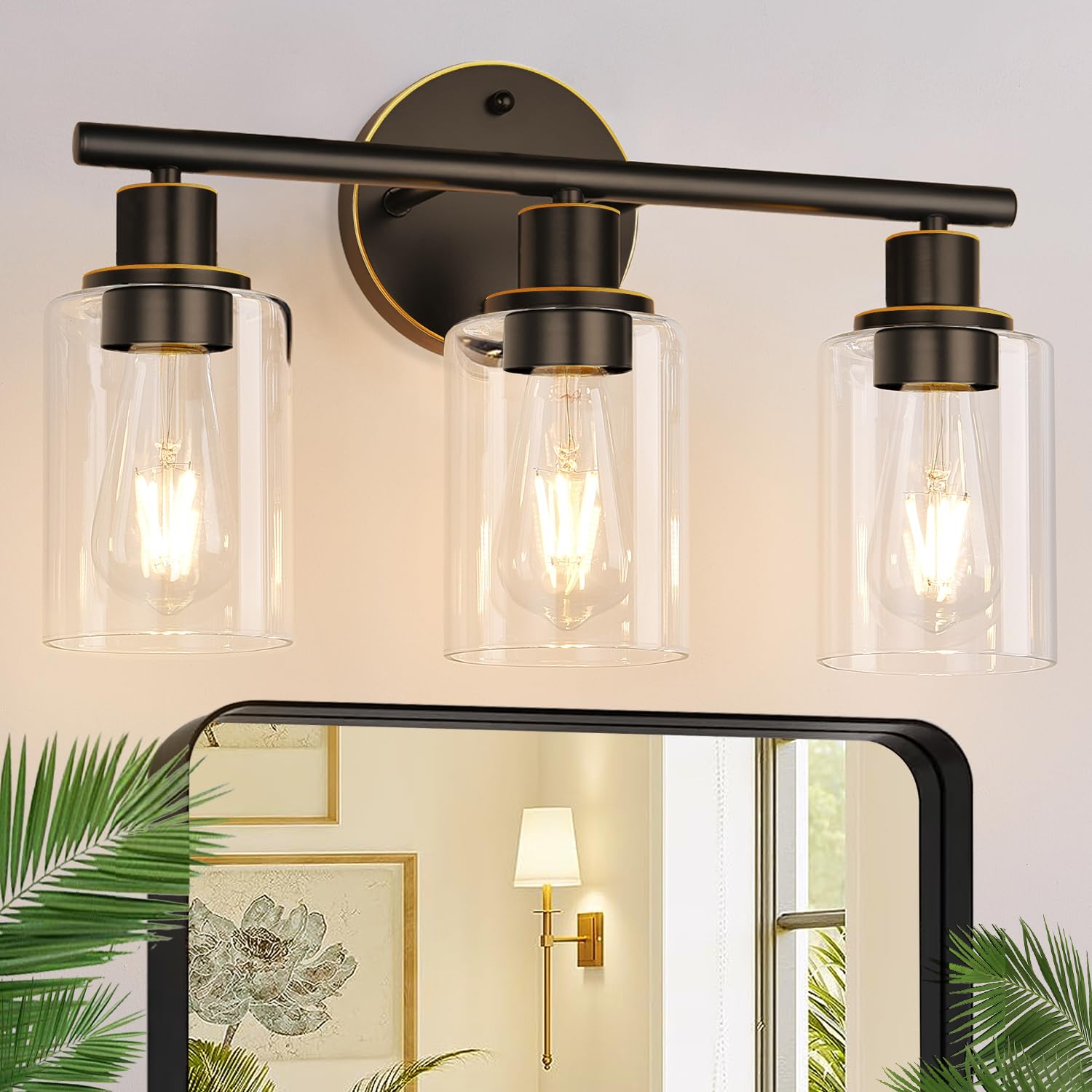 Zarbitta 3-light bathroom light with bronze finish and clear glass for a luxurious glow.