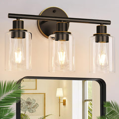 Zarbitta 3-light bathroom light with bronze finish and clear glass for a luxurious glow.