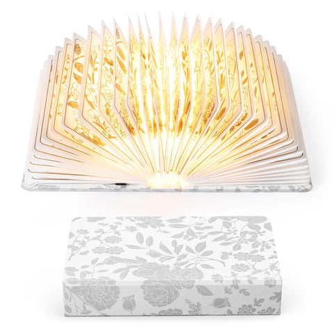 ZBOLE Floral Print Book Light opened cover for cozy nighttime reading glow.