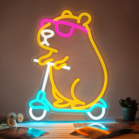 Zidoni Capybara Neon Sign with scooter on wall adds playful decor to kids' rooms.