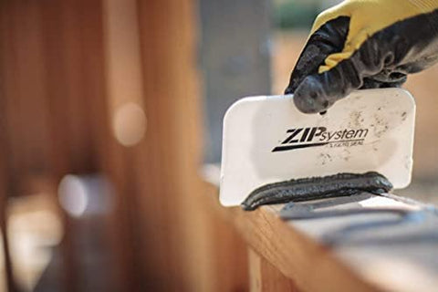 ZIP System Liquid Flash bonding to damp surfaces for reliable flashing integration.
