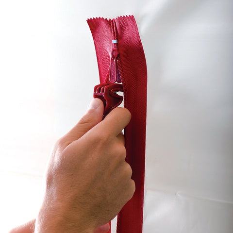 ZIPWALL heavy-duty zipper in use forms a doorway in plastic barrier.