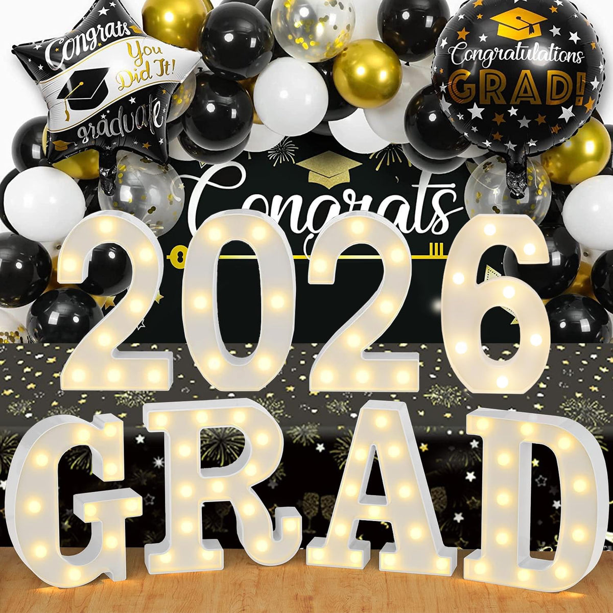 ZOMPAKER Grad marquee letters on table create warm graduation ambiance.