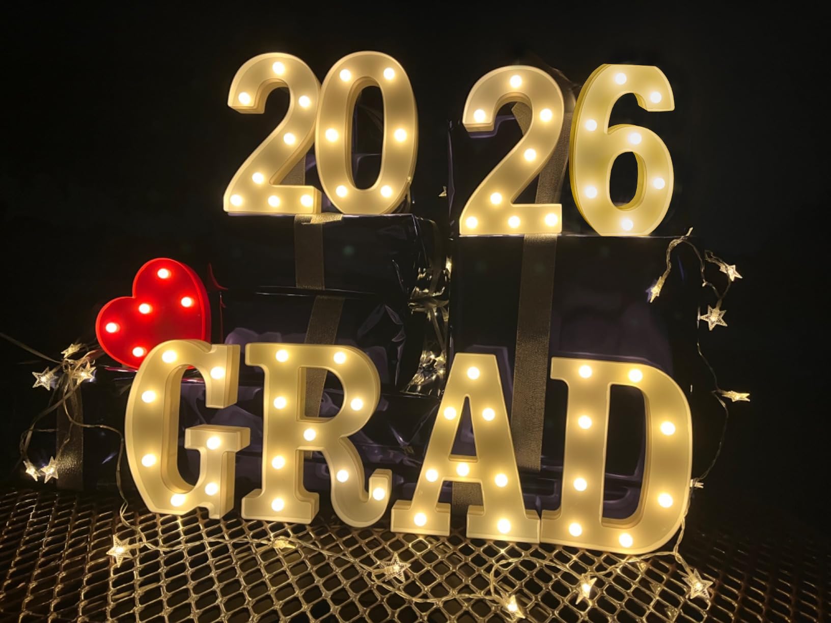 ZOMPAKER Grad letters mounted on wall for festive year display.