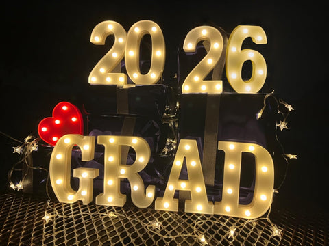 ZOMPAKER Grad letters mounted on wall for festive year display.