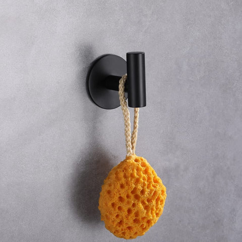 Hook installed on a tiled surface holding towels and robes.